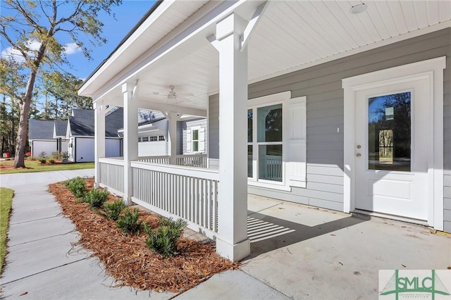 entrance to property with ceiling fan and a porch