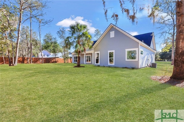 back of house with a yard and central AC unit