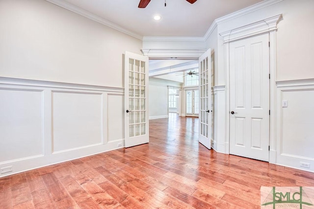 unfurnished room featuring french doors, ceiling fan, ornamental molding, and light hardwood / wood-style floors