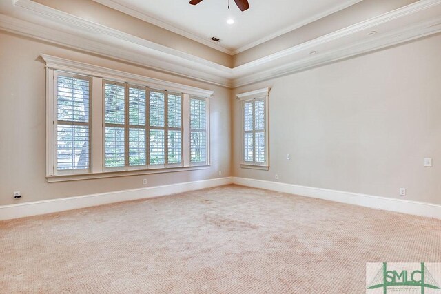 carpeted spare room featuring crown molding and ceiling fan