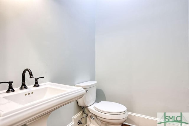 bathroom featuring sink and toilet