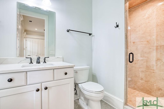 bathroom featuring vanity, toilet, and an enclosed shower