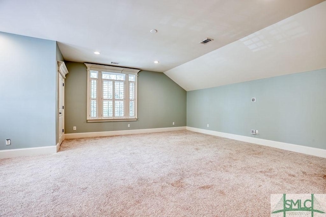 bonus room featuring lofted ceiling and light colored carpet