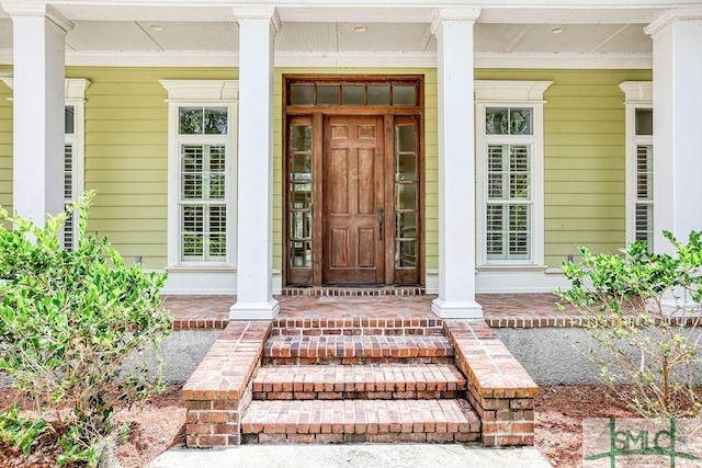 view of exterior entry featuring a porch