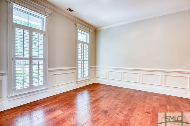 unfurnished room with hardwood / wood-style floors and a healthy amount of sunlight