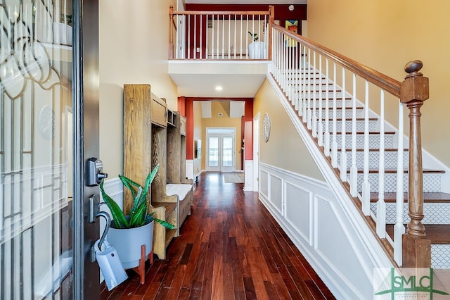 foyer featuring french doors, dark hardwood / wood-style floors, and a high ceiling