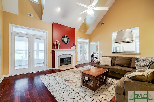 living room featuring a fireplace, wood-type flooring, ceiling fan, high vaulted ceiling, and french doors