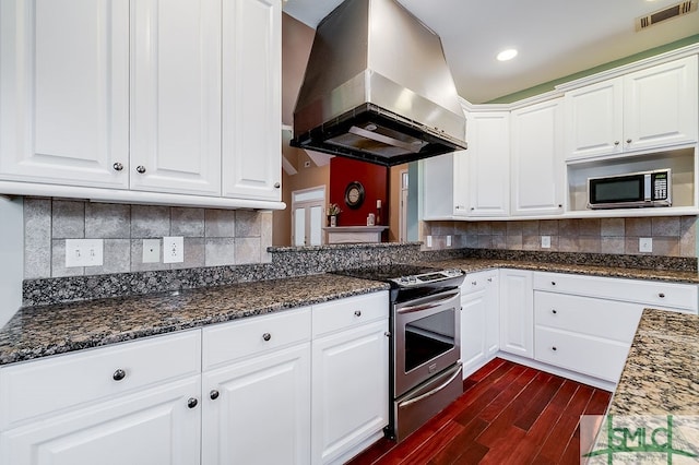 kitchen with appliances with stainless steel finishes, dark hardwood / wood-style floors, tasteful backsplash, and island range hood