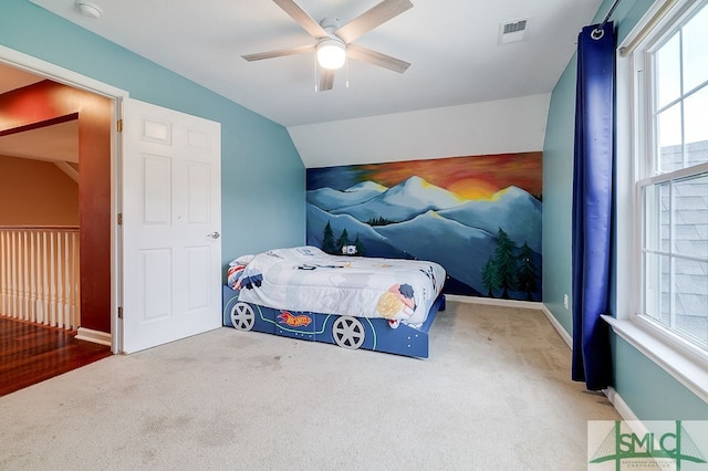 carpeted bedroom with vaulted ceiling and ceiling fan