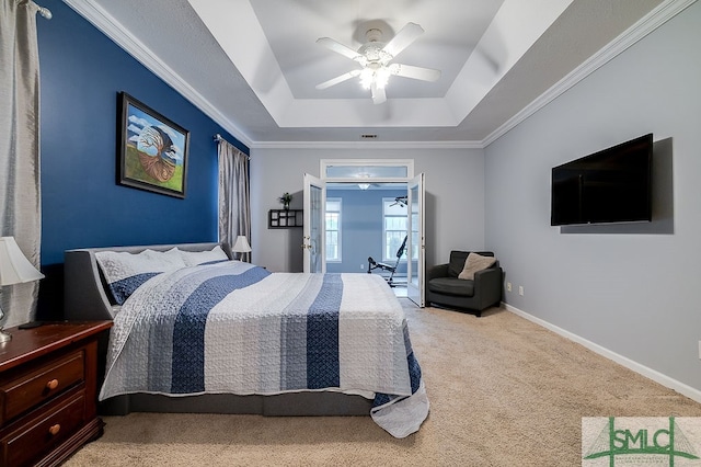 bedroom with carpet flooring, a raised ceiling, crown molding, and ceiling fan