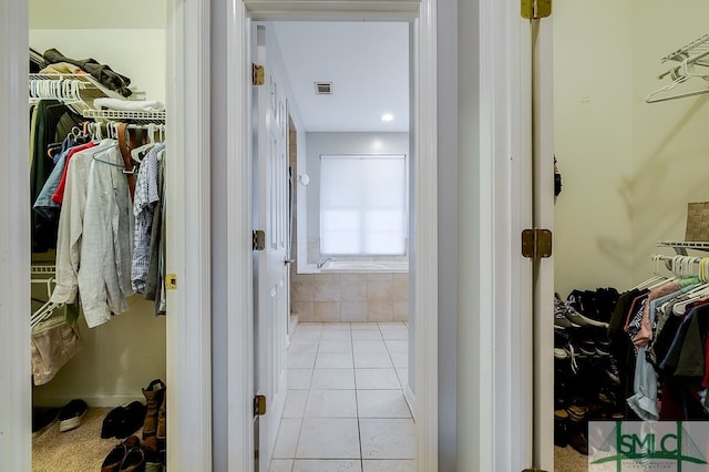 hallway with tile patterned floors