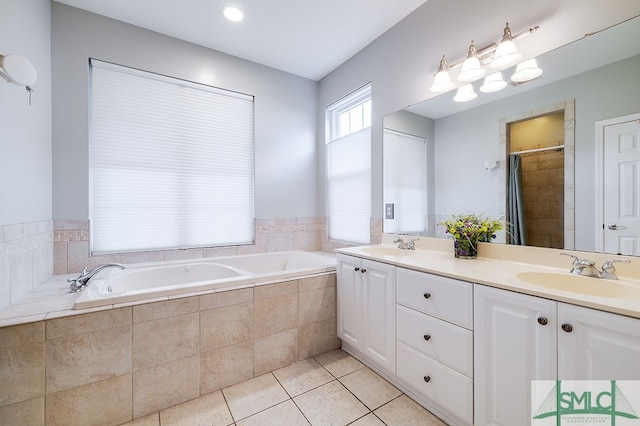 bathroom with dual vanity, tiled tub, and tile patterned flooring