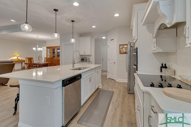 kitchen featuring pendant lighting, dishwasher, a kitchen island with sink, white cabinets, and sink