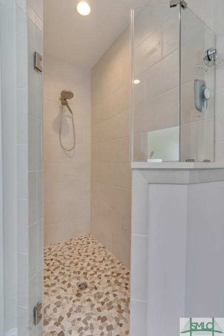 bathroom featuring a shower with door