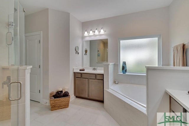 bathroom with tile patterned floors, vanity, and shower with separate bathtub