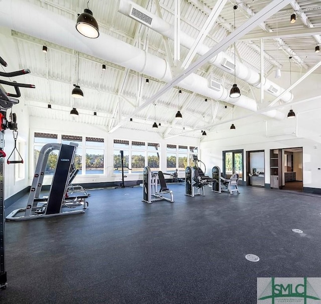 gym featuring high vaulted ceiling and a wealth of natural light