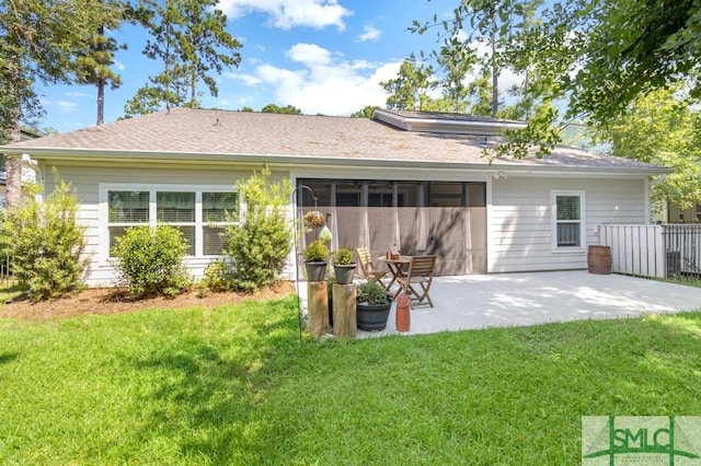 back of house with a yard and a patio