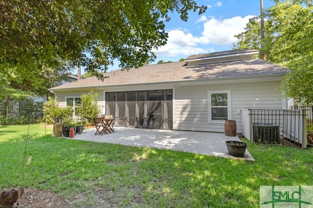 back of house featuring a lawn and a patio