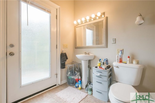 bathroom with tile patterned flooring and toilet