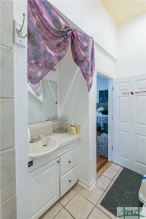 bathroom featuring tile patterned flooring and vanity