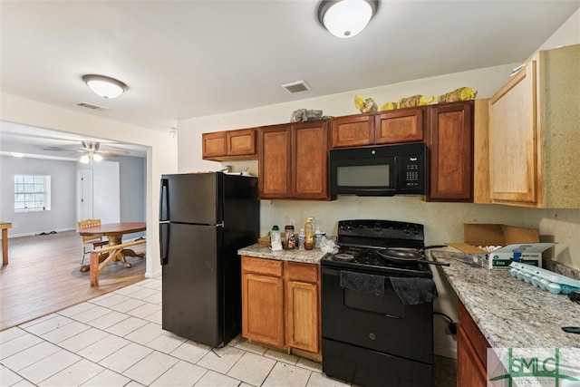 kitchen featuring black appliances, light tile patterned floors, and ceiling fan