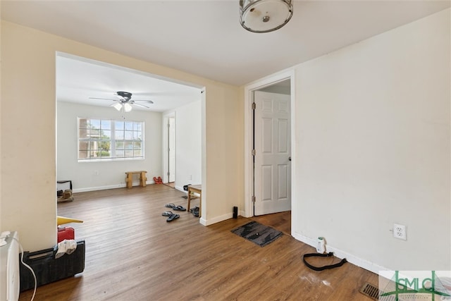 interior space featuring wood-type flooring and ceiling fan