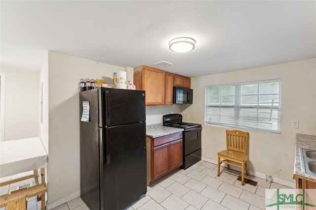 kitchen featuring black appliances and light tile patterned floors