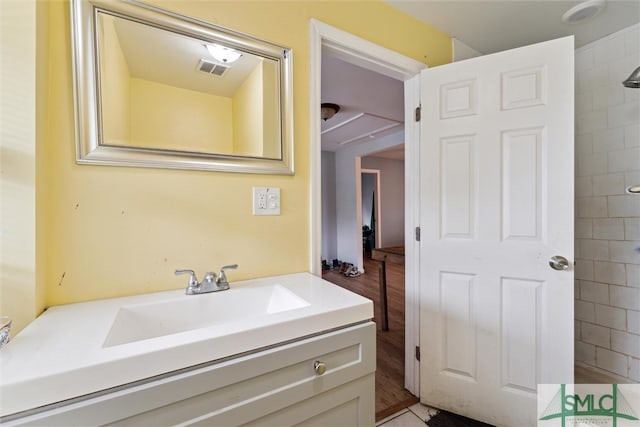 bathroom with vanity and hardwood / wood-style flooring