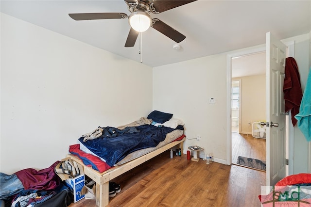 bedroom with hardwood / wood-style floors and ceiling fan