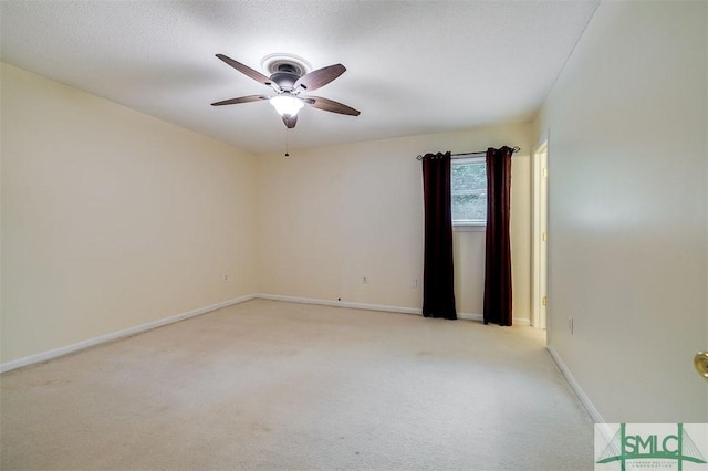 carpeted empty room featuring a textured ceiling and ceiling fan