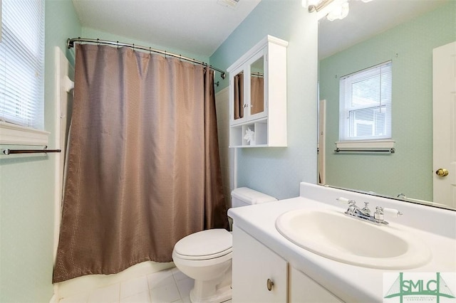 bathroom with vanity, curtained shower, and toilet