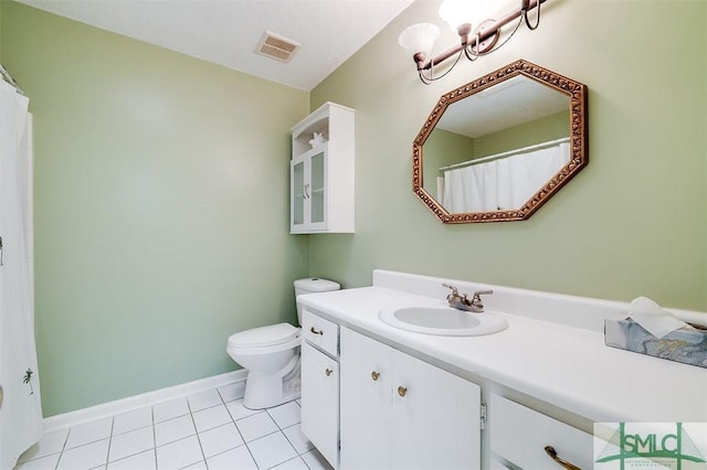 bathroom featuring tile patterned floors, vanity, toilet, and a chandelier