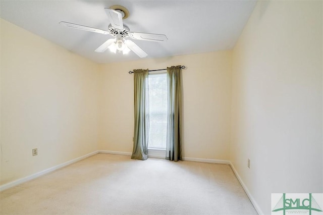 carpeted spare room with ceiling fan