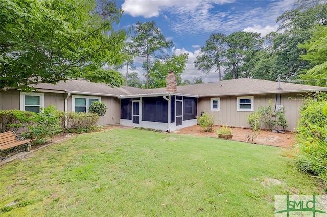 back of property featuring a lawn and a sunroom