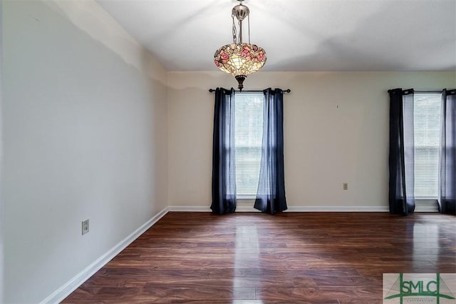 spare room featuring dark wood-type flooring