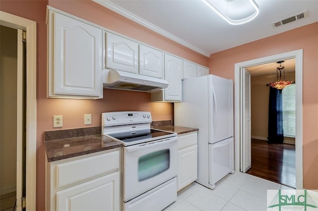 kitchen with white cabinetry, ornamental molding, light tile patterned floors, and white appliances