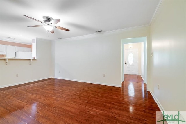 unfurnished room featuring crown molding, ceiling fan, and dark wood-type flooring