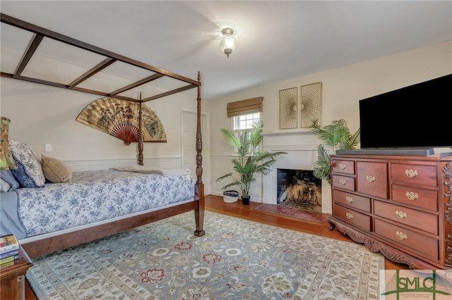 bedroom featuring a fireplace and hardwood / wood-style flooring