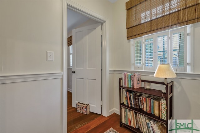 corridor with dark hardwood / wood-style flooring