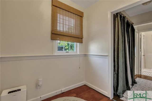 empty room with dark hardwood / wood-style floors