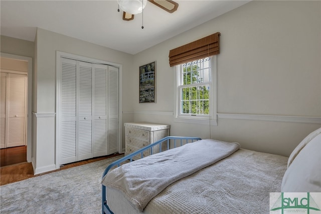 bedroom featuring ceiling fan, a closet, and hardwood / wood-style flooring