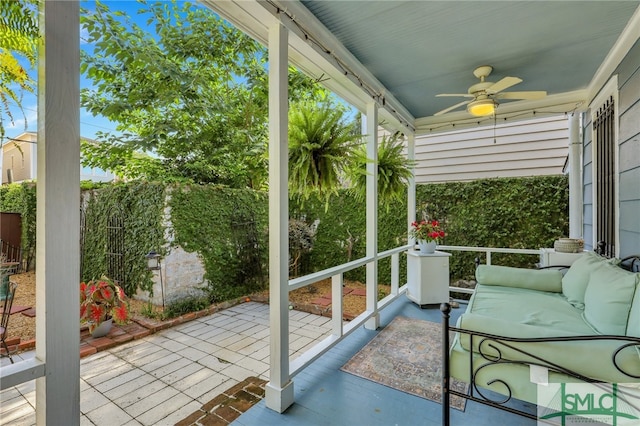 sunroom / solarium featuring ceiling fan