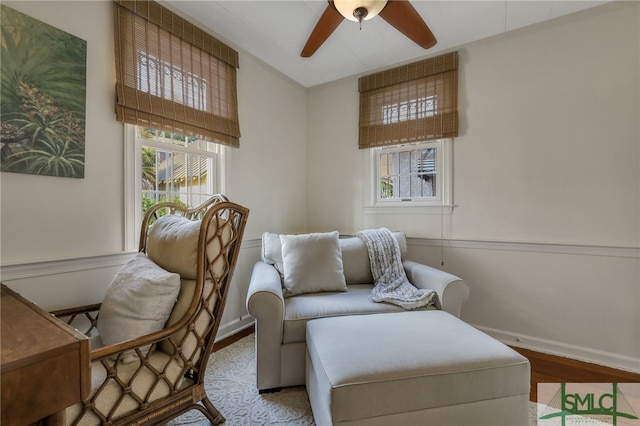 living area featuring ceiling fan and light hardwood / wood-style flooring