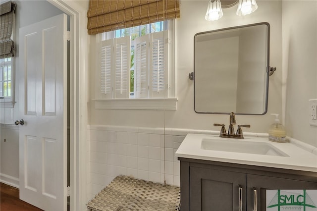 bathroom with tile walls and vanity