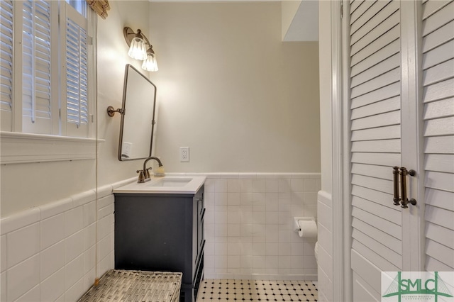 bathroom with tile walls and vanity