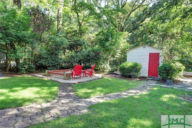 view of yard with a fire pit and a storage unit