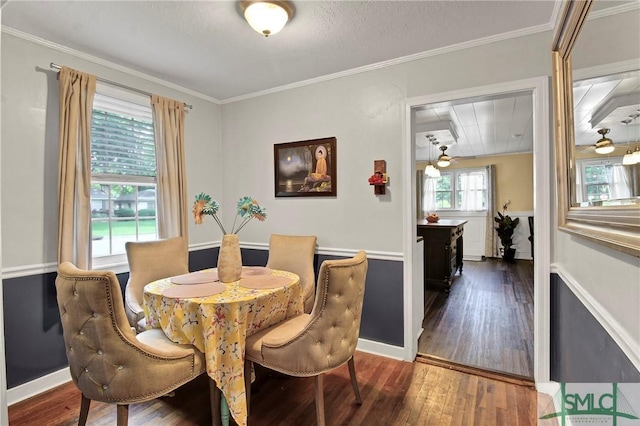 dining area with crown molding and wood-type flooring