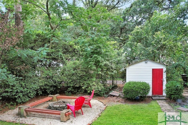 view of yard with a fire pit and a storage shed