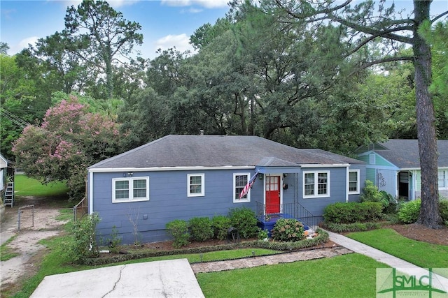 ranch-style house with a front lawn