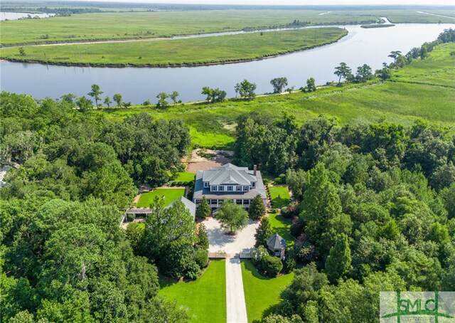 birds eye view of property featuring a water view and a rural view